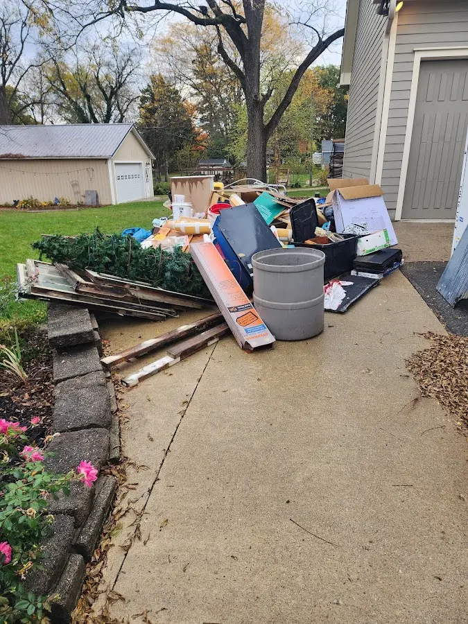 Dumpster being loaded with debris for Roofing Dumpster Rental in Newmarket
